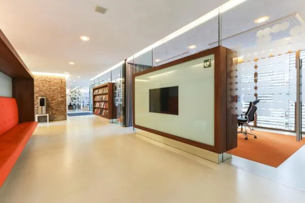 Moderne kantoorruimte aan de Charloisse Lagedijk met glazen wanden, zitgedeelte, boekenkast en vergaderruimte.